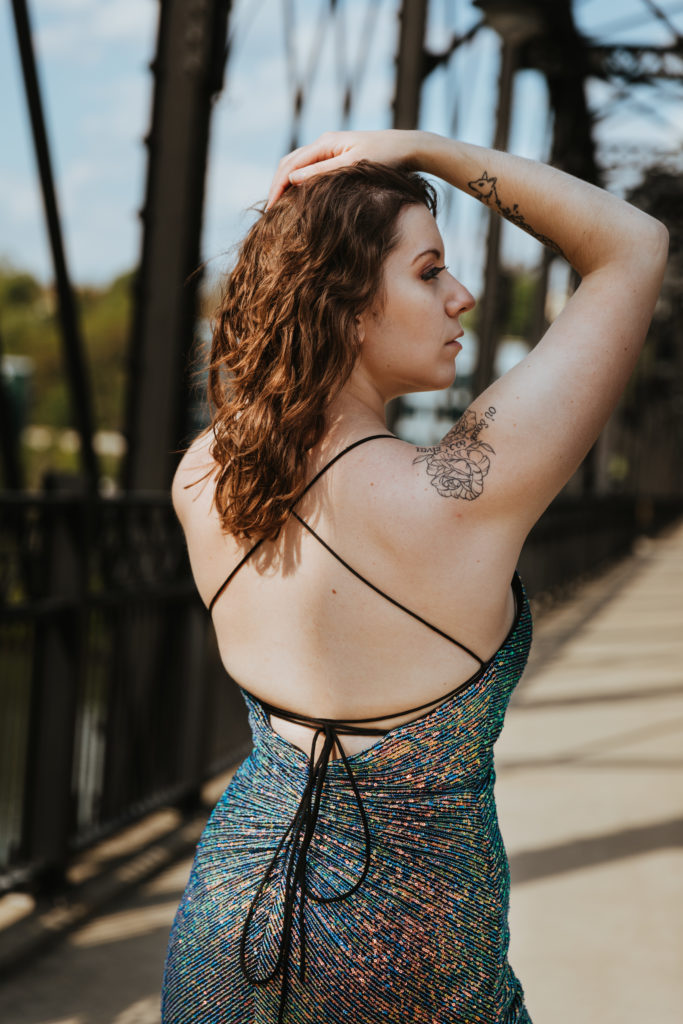 Natalie Vaia posing with her back showing on the Hot Metal Bridge in Pittsburgh